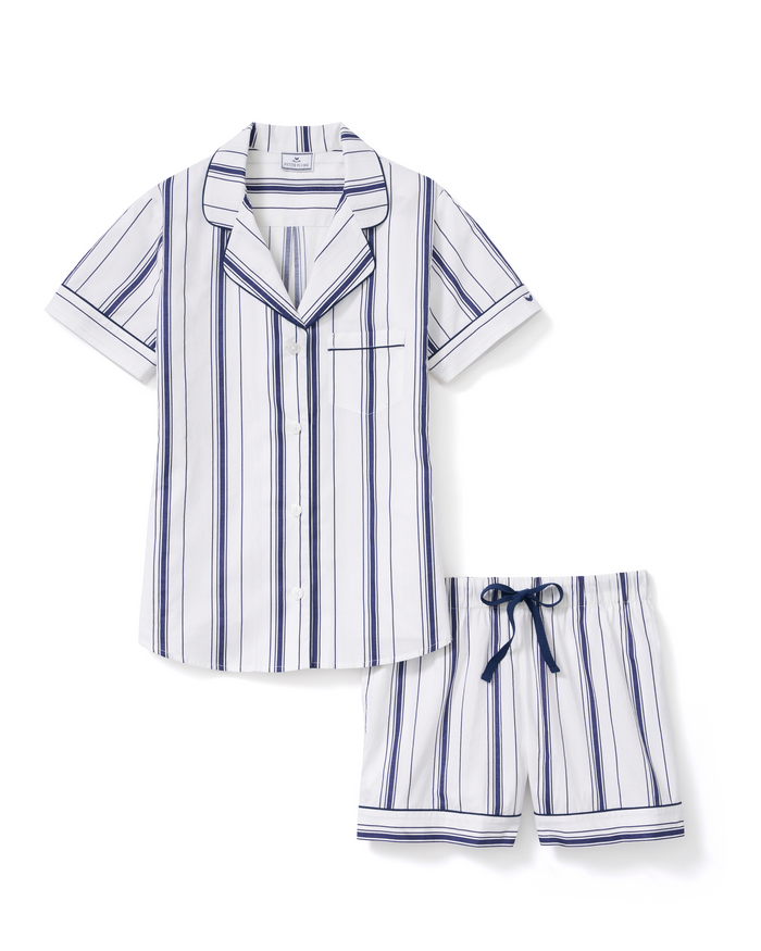 Women’s Poplin Short Sleeve Short Set in Parlor Stripe features a short-sleeve, button-up pajama top and coordinating shorts with blue and navy vertical stripes on a white background, finished with a blue drawstring at the waist.