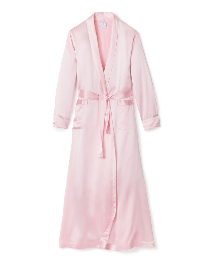 The Womens Silk Long Robe in Pink by Petite Plume epitomizes luxury sleepwear with its shawl collar, matching belt, and long sleeves. Its lustrous texture offers unparalleled comfort and indulgence.