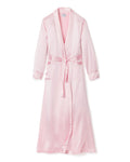 The Womens Silk Long Robe in Pink by Petite Plume epitomizes luxury sleepwear with its shawl collar, matching belt, and long sleeves. Its lustrous texture offers unparalleled comfort and indulgence.