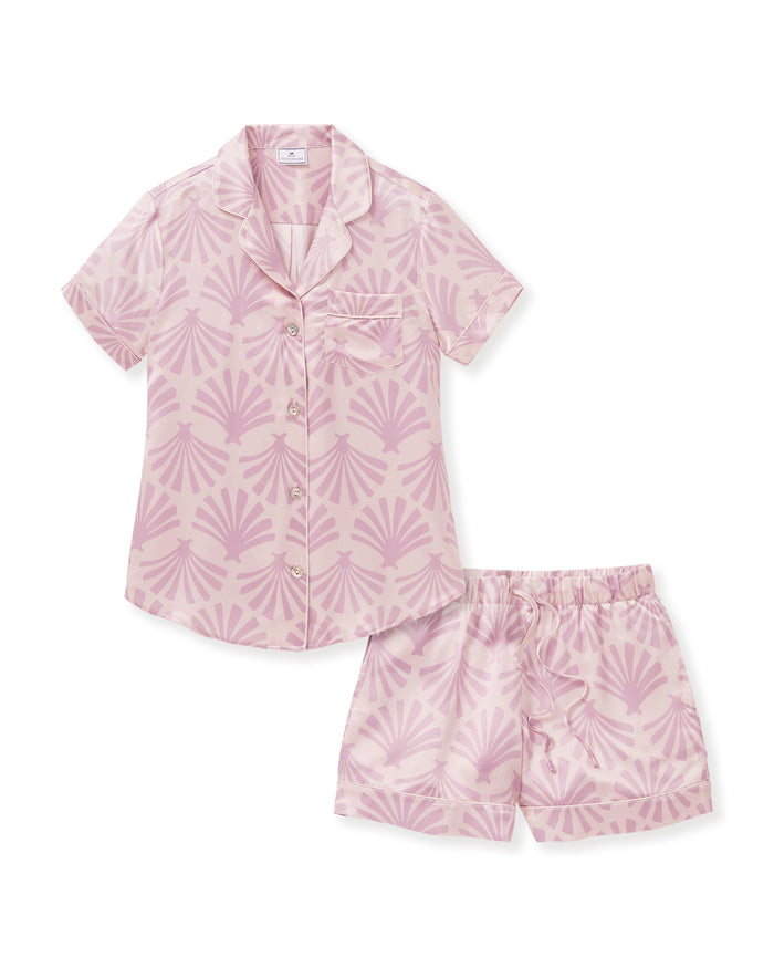 The Women's Silk Short Sleeve Short Set in Blush Tide features a matching pink button-up top and elastic-waist shorts, both adorned with a light purple geometric fan pattern.