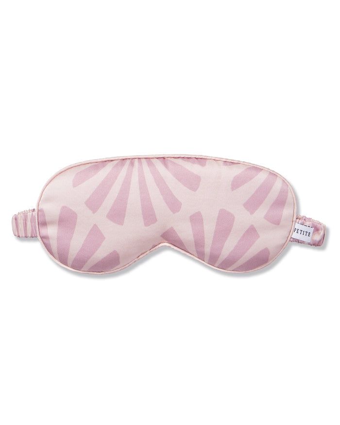 The Women's Silk Sleep Mask in Blush Tide features a sunburst pattern and elastic strap, shown on a white background.