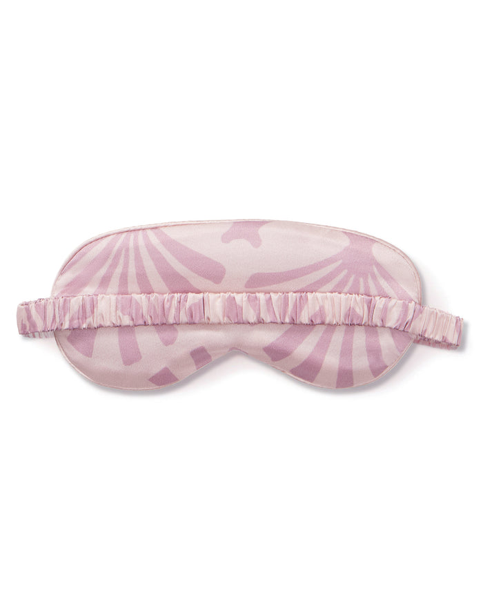 The Women's Silk Sleep Mask in Blush Tide features a sunburst pattern and elastic strap, shown on a white background.