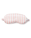 The Womens Silk Sleep Mask in Pink Stripe from Petite Plume features a cushioned design for luxurious comfort and a PETITE label on its strap, enhancing your rest.
