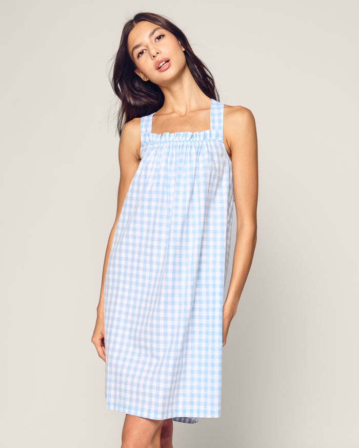The Women's Twill Annabelle Nightgown in Light Blue Gingham features wide shoulder straps, a light blue and white gingham pattern, a gathered elastic neckline, relaxed fit, and above-knee length.