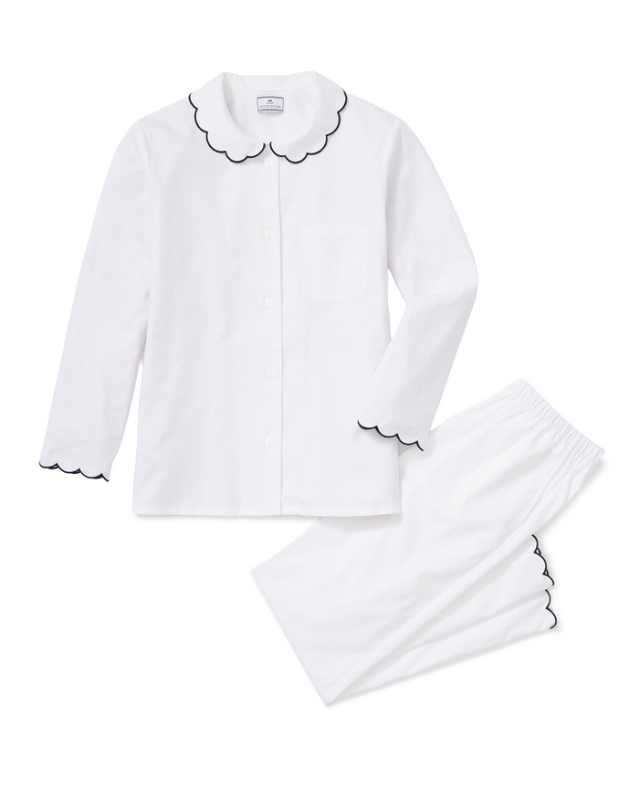 Women’s Twill Colette Pajama Set in White with Navy Piping features a long-sleeve button-up top with a chest pocket, and matching pants, both accented with navy piping along the collar, cuffs, and pant hems.