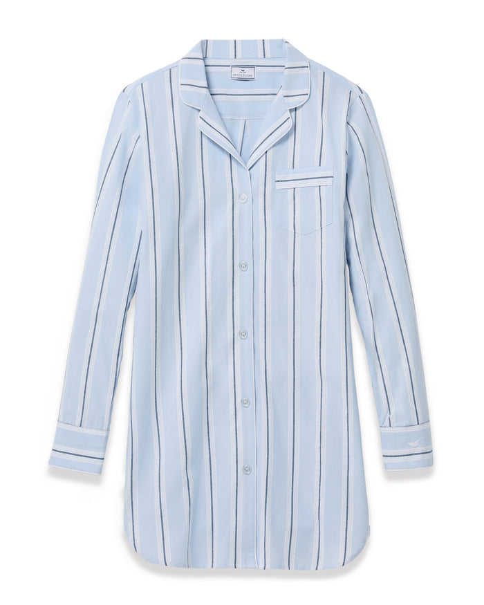 Women’s Twill Nightshirt in Coastal Stripe, featuring a light blue color with dark and white vertical stripes, long sleeves, a chest pocket, and a notched collar. The nightshirt is neatly laid out on a white background.