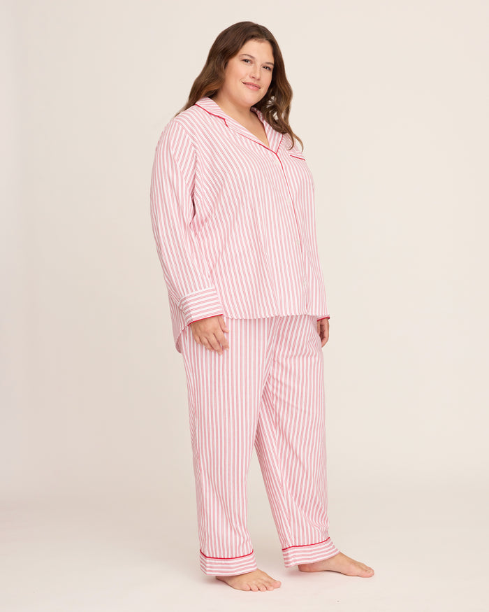 The Womens Twill Pajama Set in Antique Red Ticking by Petite Plume features a white shirt with red vertical stripes, front pocket, and button closure. Made from soft, lightweight fabric, the classic pattern offers comfort for sleepwear or casual wear.