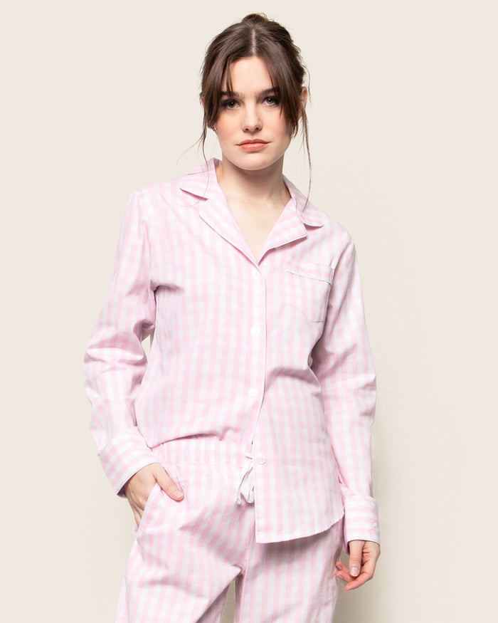 Women's Twill Pajama Set in Pink Gingham features a long-sleeve button-up top with a chest pocket and matching drawstring pants, shown laid flat on a white background.