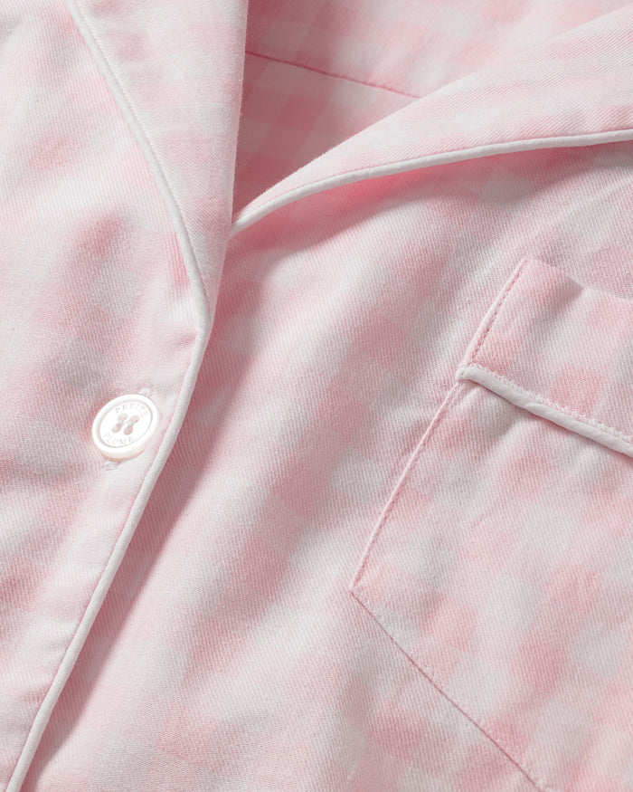 Women's Twill Pajama Set in Pink Gingham features a long-sleeve button-up top with a chest pocket and matching drawstring pants, shown laid flat on a white background.
