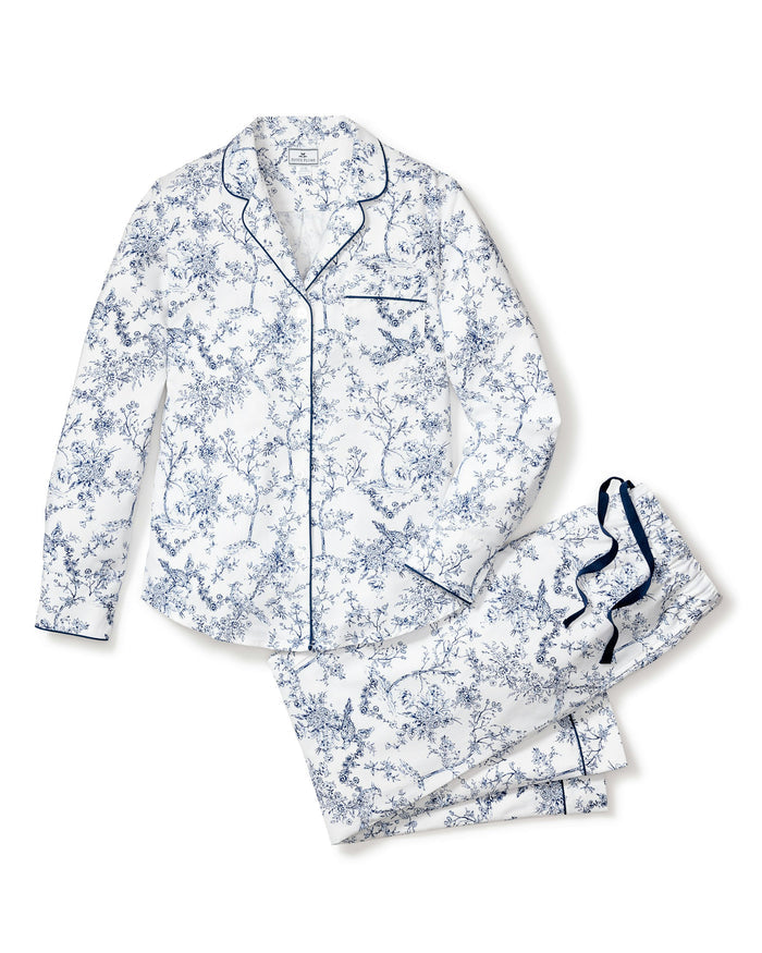 Women’s Twill Pajama Set in Timeless Toile features a white long-sleeve button-up top with a blue floral toile pattern, accented by navy piping and a chest pocket, paired with matching drawstring waist pants.