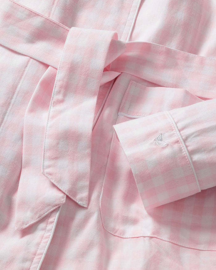The Women's Twill Robe in Pink Gingham features long sleeves, a shawl collar, front pockets, and a matching fabric belt at the waist, shown laid flat on a white background.