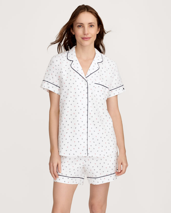 A woman wearing the Women’s Twill Short Sleeve Short Set in Anchors Away White, featuring a small print pattern, stands against a plain light background.