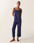 A woman stands barefoot against a plain light background, wearing the Women's Voile Fleur Cami Pant Set in Navy.