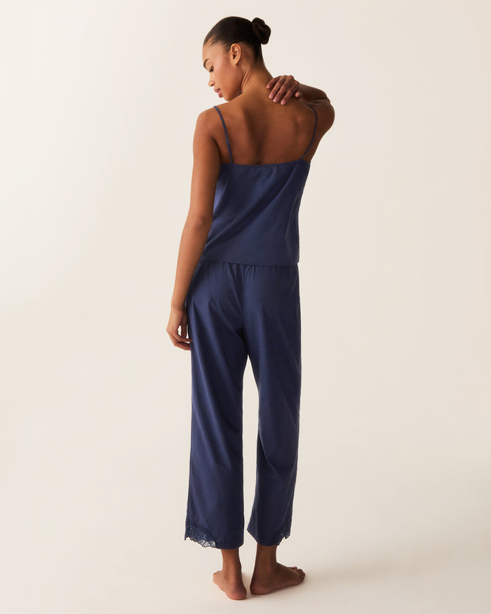 A woman stands barefoot against a plain light background, wearing the Women's Voile Fleur Cami Pant Set in Navy.