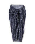 The Women’s Voile Pareo in Nautical Knots, featuring white geometric patterns on navy blue fabric and tied in a knot at the front, is displayed against a white background.